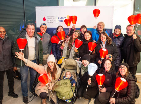 A light the night team holding their lanterns